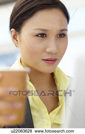 Stock Photo - Young businesswoman at work. Fotosearch