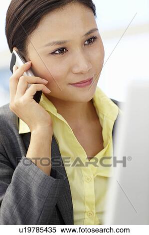 Stock Photography - Young businesswoman at work. Fotosearch