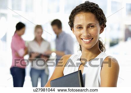 Young businesswoman in office View Large Photo Image Picture - Young businesswoman in office. Fotosearch