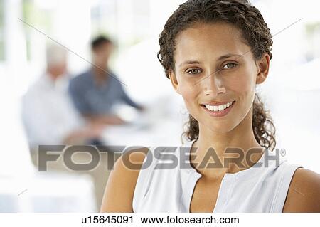 Stock Image - Young businesswoman in office. Fotosearch