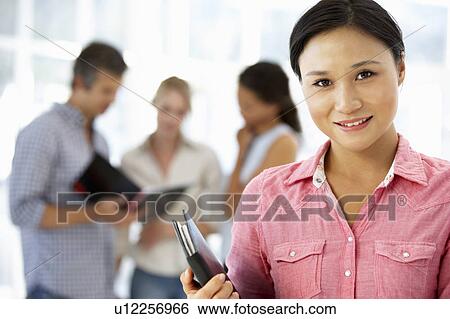 Stock Photograph - Young businesswoman in office. Fotosearch