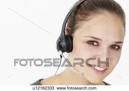 Young businesswoman wearing headset View Large Photo Image Stock Image - Young businesswoman wearing headset. Fotosearch