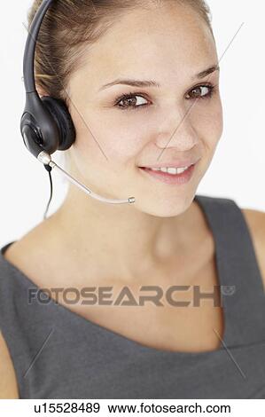 Stock Photo - Young businesswoman wearing headset. Fotosearch