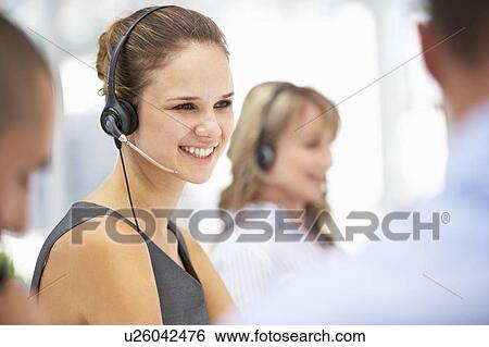 Young businesswoman wearing headset View Large Photo Image Stock Photograph - Young businesswoman wearing headset. Fotosearch