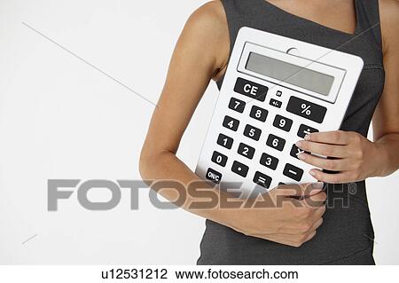 Young businesswoman with giant calculator View Large Photo Image Stock Image - Young businesswoman with giant calculator. Fotosearch