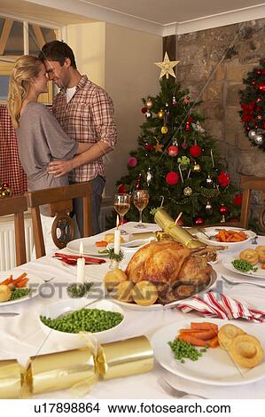 Picture - Young couple at home at Christmas. Fotosearch