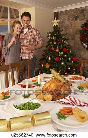 Stock Image - Young couple at home at Christmas. Fotosearch