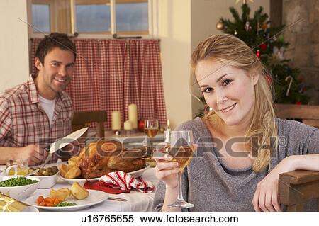 Young couple having Christmas dinner View Large Photo Image Stock Photography - Young couple having Christmas dinner. Fotosearch