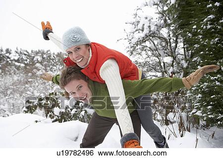 Young couple having fun in snow View Large Photo Image Stock Photograph - Young couple having fun in snow. Fotosearch
