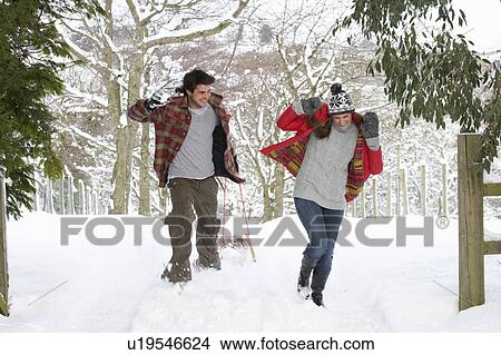 Picture - Young couple having snowball fight. Fotosearch