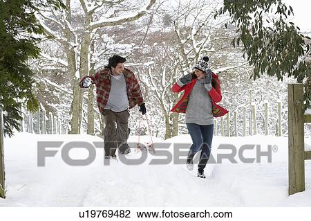 Young couple having snowball fight View Large Photo Image Stock Image - Young couple having snowball fight. Fotosearch