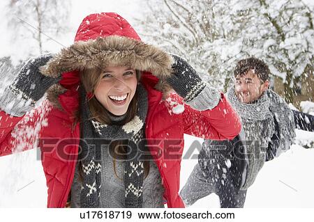 Young couple having snowball fight View Large Photo Image Stock Photo - Young couple having snowball fight. Fotosearch