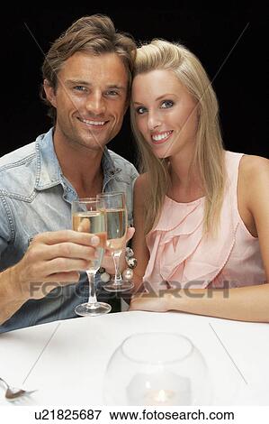 Stock Photo - Young couple in restaurant. Fotosearch