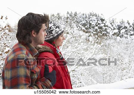 Stock Image - Young couple in snow. Fotosearch