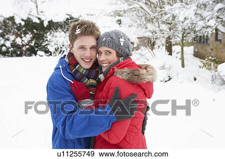 Stock Photo - Young couple in snow. Fotosearch