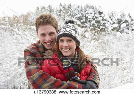 Young couple in snow View Large Photo Image Stock Photo - Young couple in snow. Fotosearch