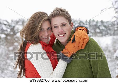 Stock Photograph - Young couple in snow. Fotosearch