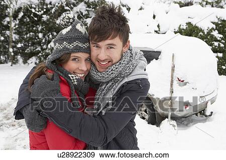 Young couple in snow with car View Large Photo Image Stock Photo - Young couple in snow with car. Fotosearch