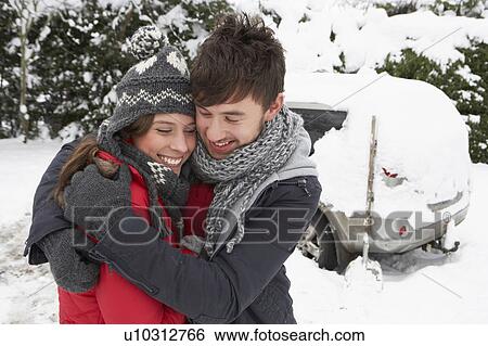Young couple in snow with car View Large Photo Image Stock Photograph - Young couple in snow with car. Fotosearch