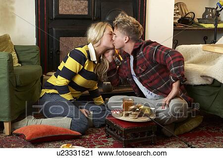 Stock Image - Young couple making toast on open fire. Fotosearch