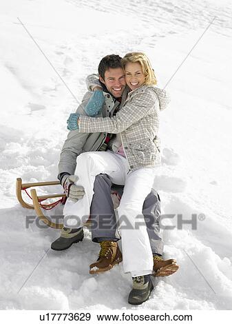 Stock Photo - Young Couple On A Sled. Fotosearch