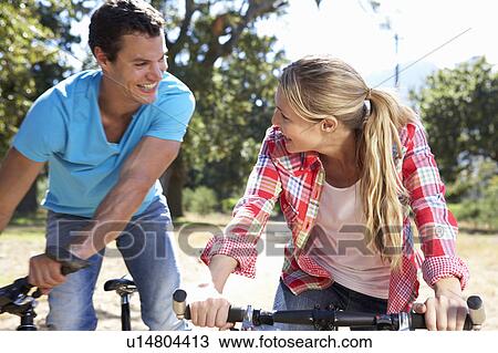 Young couple on country bike ride View Large Photo Image Stock Image - Young couple on country bike ride. Fotosearch