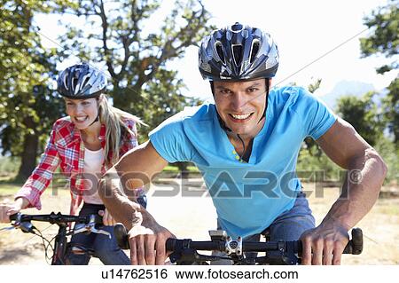 Young couple on country bike ride View Large Photo Image Stock Photograph - Young couple on country bike ride. Fotosearch