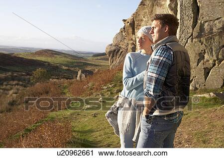 Young couple on country walk View Large Photo Image Stock Image - Young couple on country walk. Fotosearch