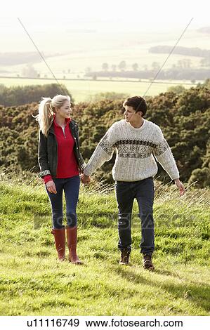 Young couple on country walk View Large Photo Image Stock Photo - Young couple on country walk. Fotosearch