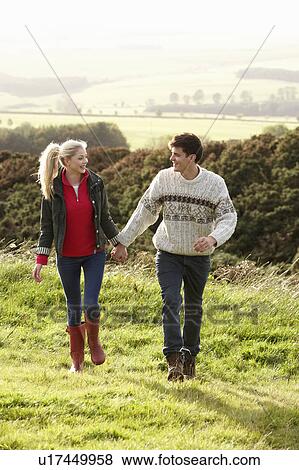 Young couple on country walk View Large Photo Image Stock Photo - Young couple on country walk. Fotosearch