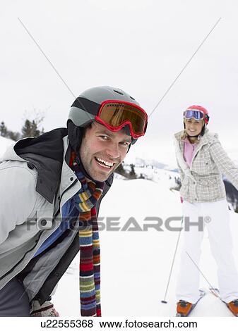 Stock Photo - Young Couple On Ski Vacation. Fotosearch