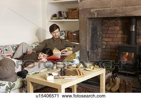 Young couple relaxing by fire View Large Photo Image Stock Image - Young couple relaxing by fire. Fotosearch