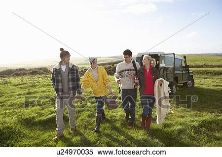 Stock Photography - Young couples going for picnic. Fotosearch