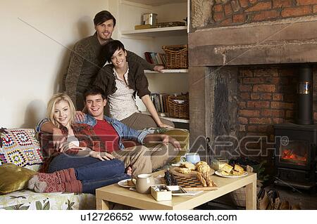 Young couples in cosy cottage View Large Photo Image Stock Image - Young couples in cosy cottage. Fotosearch