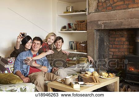 Stock Image - Young couples in cosy cottage. Fotosearch