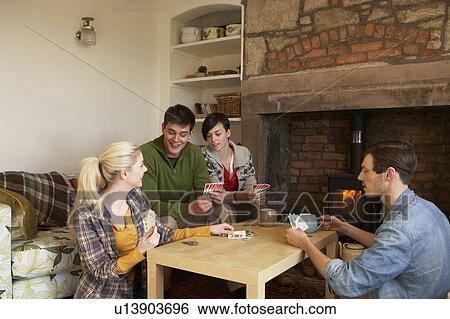 Stock Photograph - Young couples in cosy cottage. Fotosearch