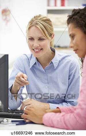 Stock Photograph - Young doctor with female patient. Fotosearch