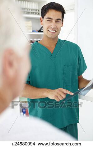 Picture - Young doctor with senior patient. Fotosearch