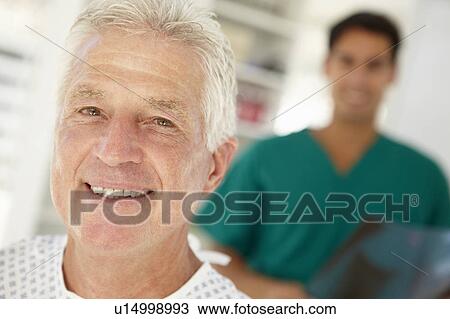 Stock Image - Young doctor with senior patient. Fotosearch