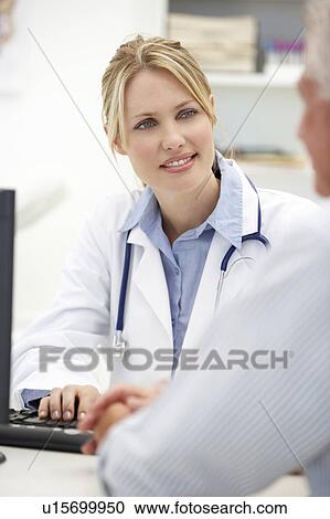 Stock Image - Young doctor with senior patient. Fotosearch