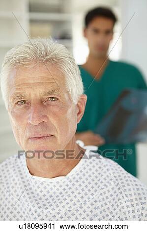 Stock Image - Young doctor with senior patient. Fotosearch
