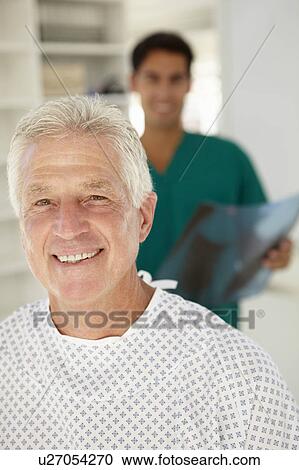 Stock Image - Young doctor with senior patient. Fotosearch