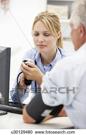 Young doctor with senior patient View Large Photo Image Stock Image - Young doctor with senior patient. Fotosearch