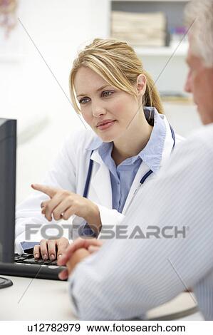 Stock Photo - Young doctor with senior patient. Fotosearch