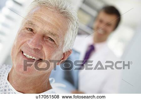 Young doctor with senior patient View Large Photo Image Stock Photo - Young doctor with senior patient. Fotosearch