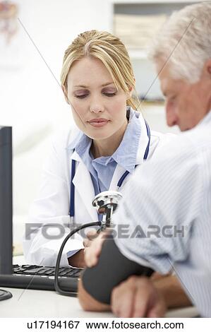 Young doctor with senior patient View Large Photo Image Stock Photo - Young doctor with senior patient. Fotosearch