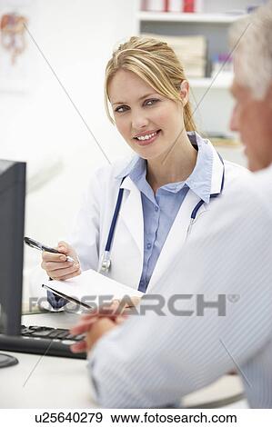 Stock Photo - Young doctor with senior patient. Fotosearch