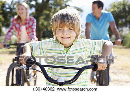 Young family on country bike ride View Large Photo Image Stock Image - Young family on country bike ride. Fotosearch