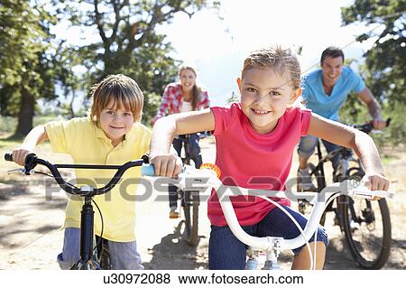 Stock Photo - Young family on country bike ride. Fotosearch