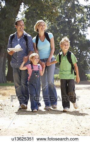 Stock Image - Young family on country walk. Fotosearch